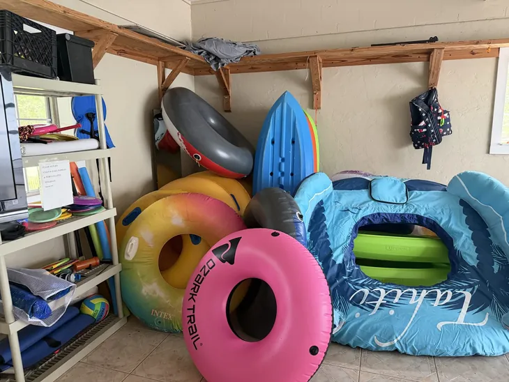The gear room stocked with tubes, floats, paddles, life jackets and disc golf discs